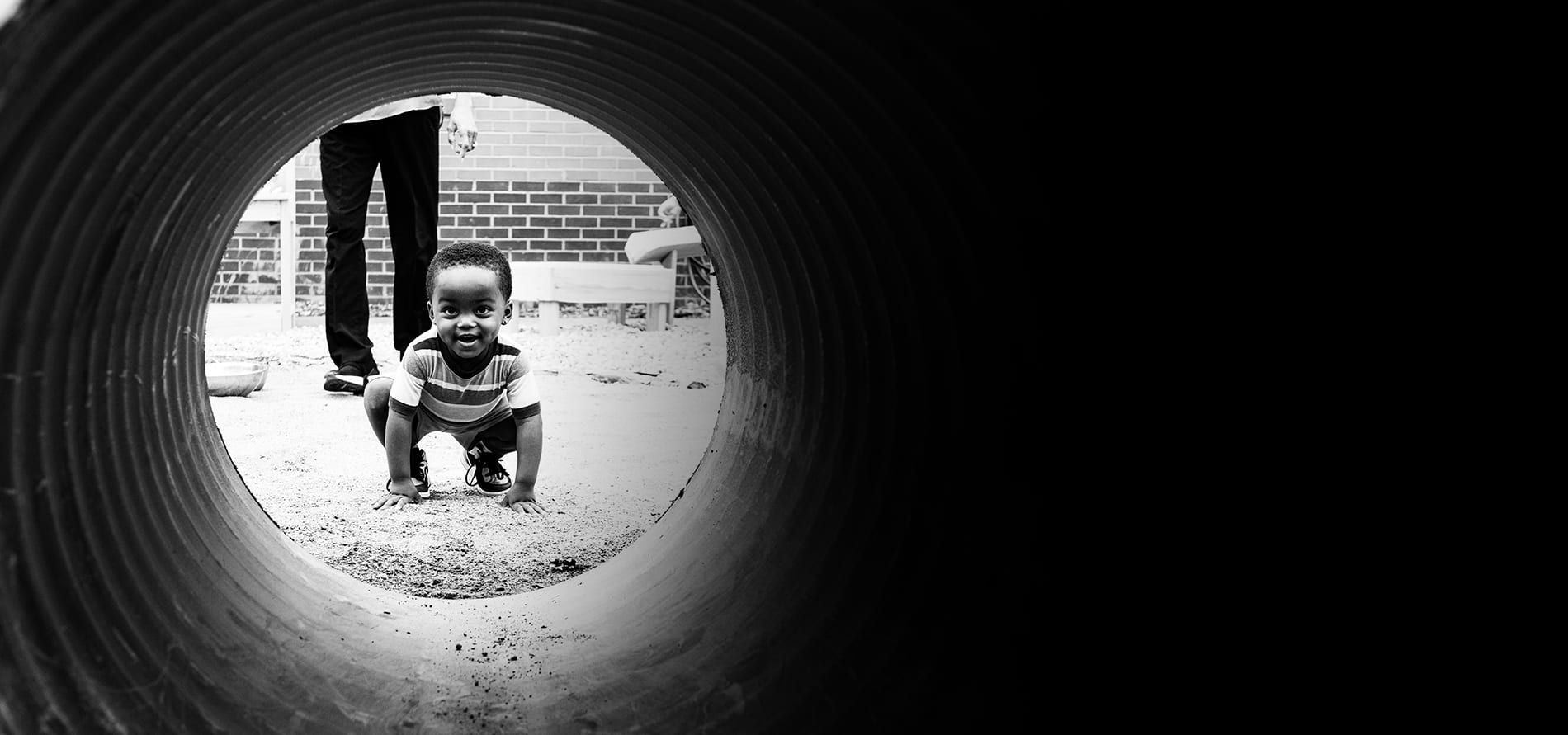 A child peeks through a tunnel